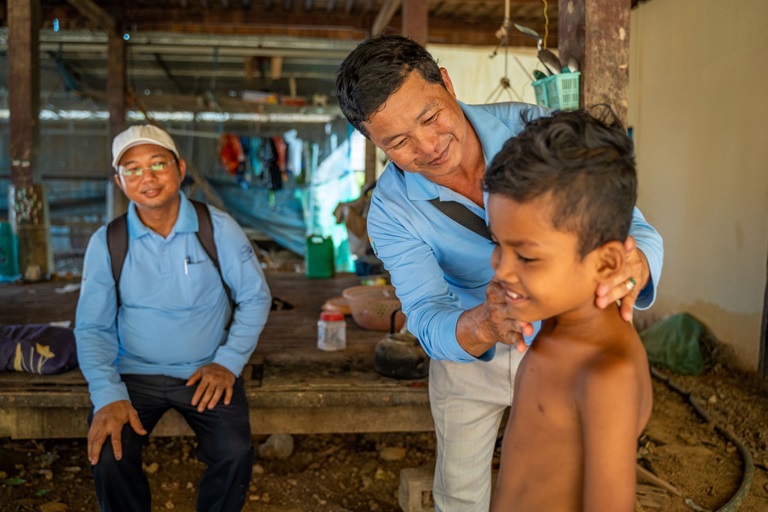 A boy is checked by a health worker in Cambodia for leprosy.
